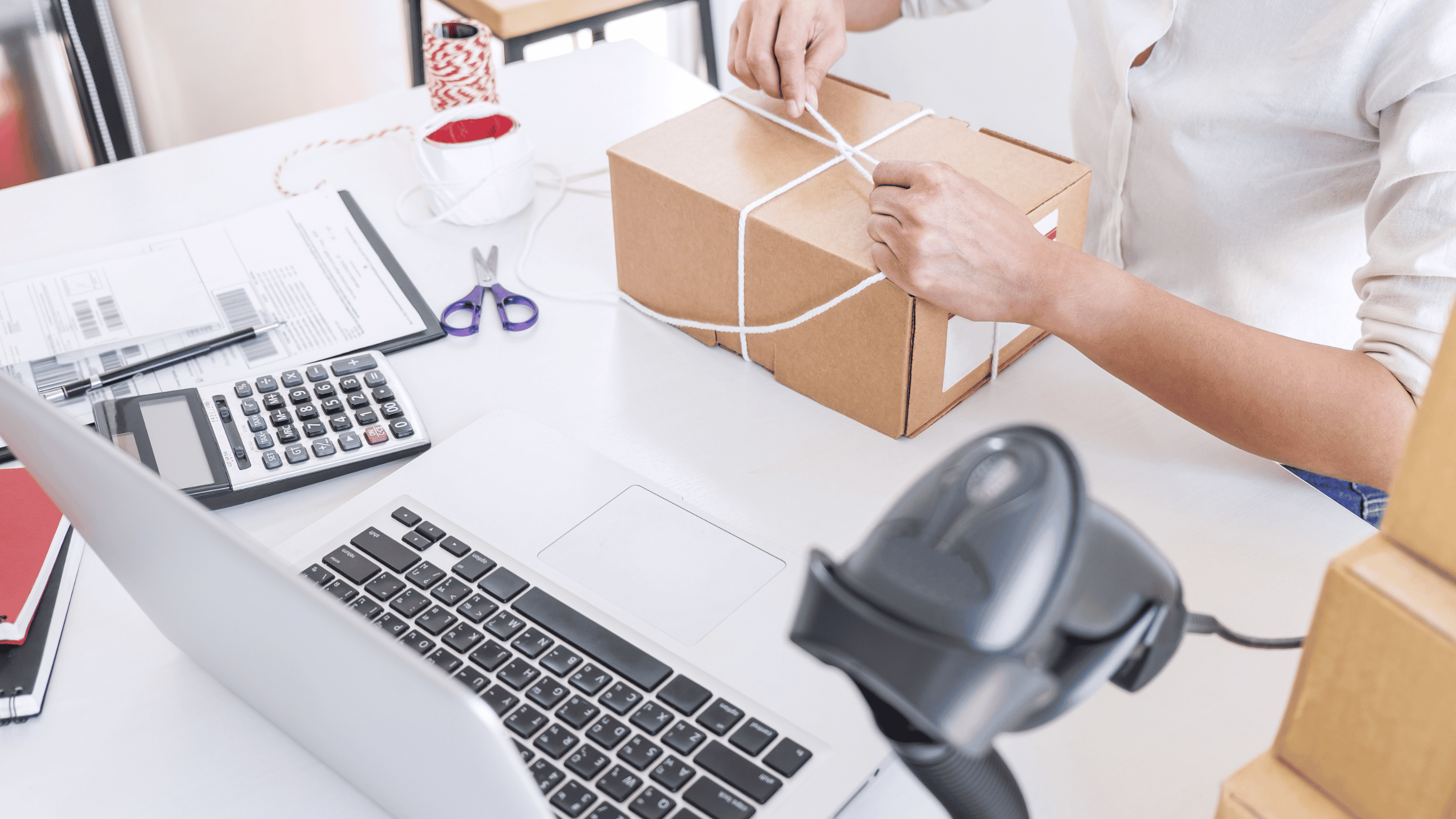 Business person tying up a package on his desk