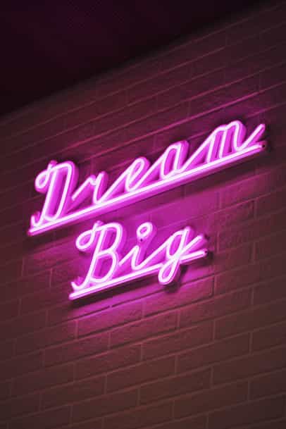 Pink Neon sign that sais "Dream Big"